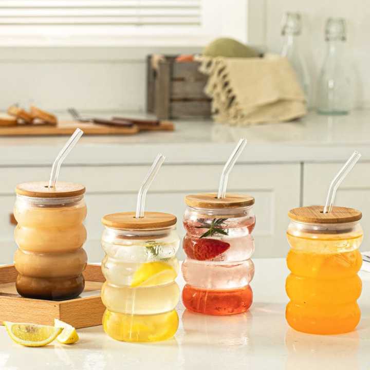 Glass sipper bottle with wooden lid and reusable straw