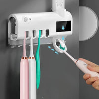 Electric toothbrush sterilizer and dispenser with UV light holder